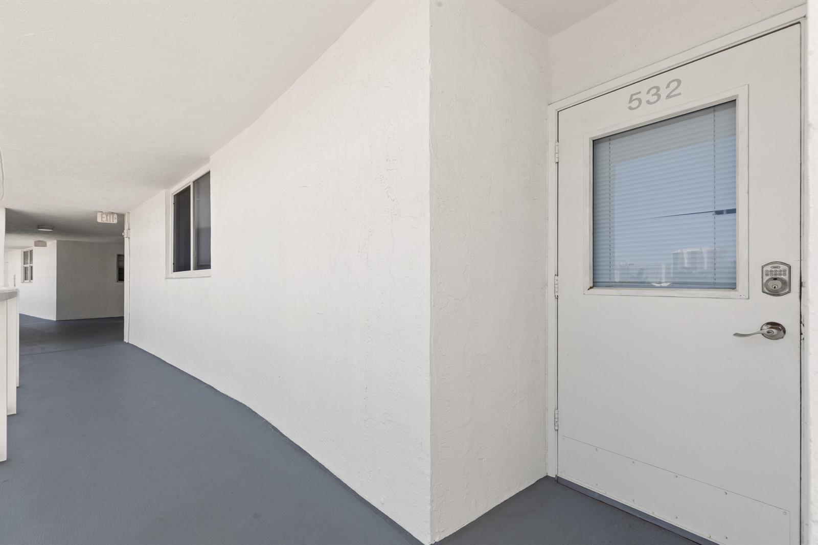 A white exterior door numbered 532 is located on a gray-floored outdoor apartment hallway — 2731 NE 14th St Causeway # 532, Pompano Beach FL 33062, POMPANO BEACH, FL
