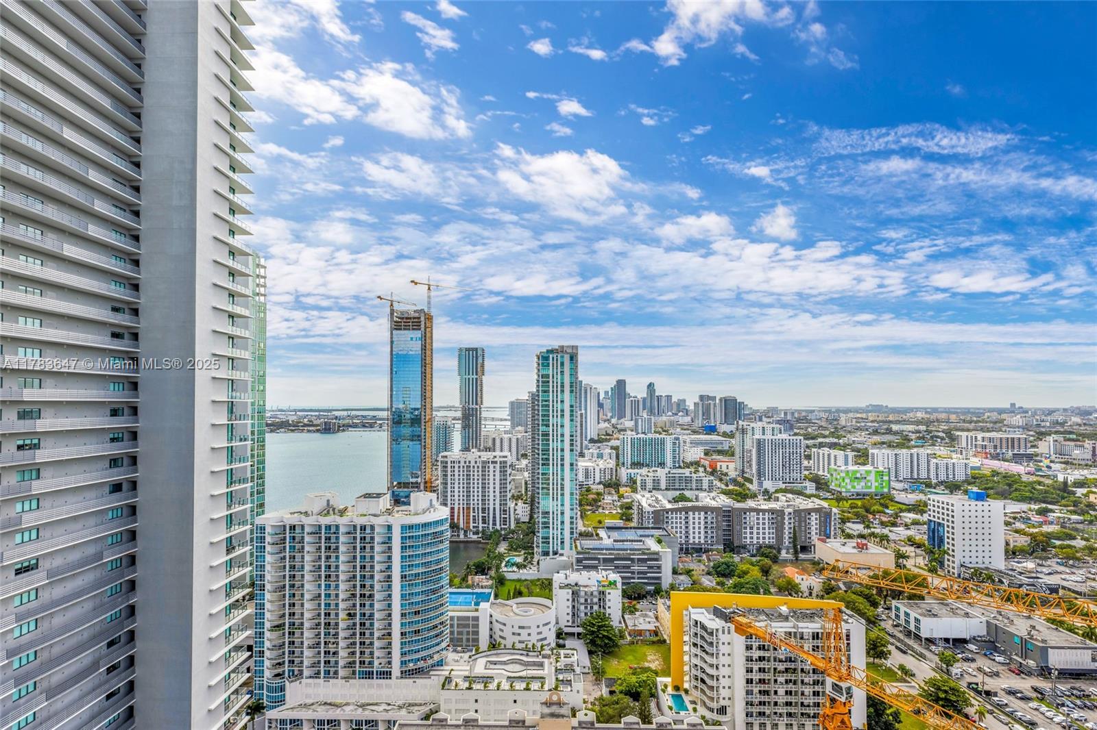 An elevated view of a dense urban skyline featuring high-rise buildings and a waterfront — 501 NE 31 St # 3307, Miami FL 33137, MIAMI, FL