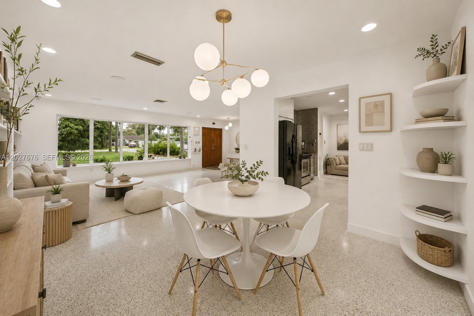 A bright, open-concept living and dining area features white walls, terrazzo flooring, and modern lighting — 14001 S Biscayne River Dr, Miami FL 33161, MIAMI, FL