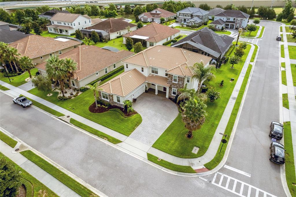 An aerial view shows a two-story suburban house with a tiled roof and paved driveway — 427 BLUE BIRCH COURT, SANFORD, FL