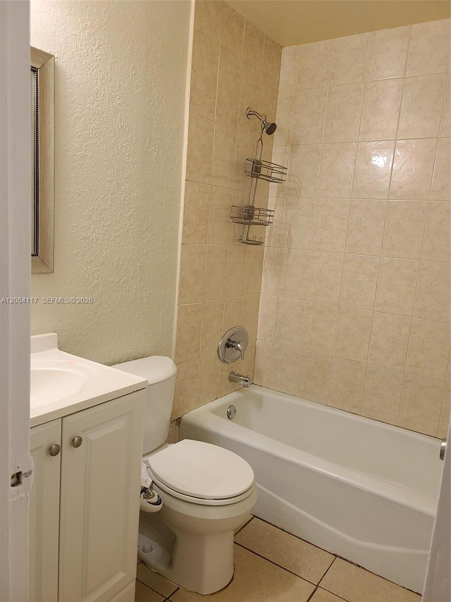 A bathroom features a white vanity, a toilet with a bidet, and a tiled shower-tub — 2117 Liberty St, Hollywood FL 33020, HOLLYWOOD, FL