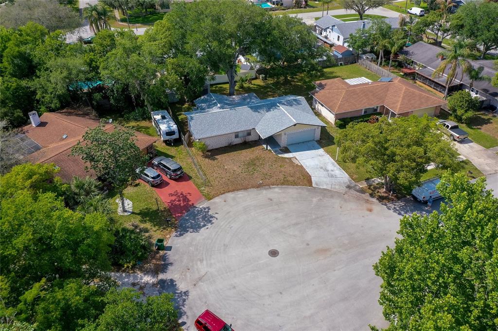 An aerial view shows a suburban house with a gray roof and a concrete driveway — 667 GEORGE MILLER CIRCLE, PORT ORANGE, FL