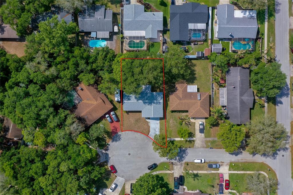 An aerial view shows a single-family home with a red property boundary outline — 667 GEORGE MILLER CIRCLE, PORT ORANGE, FL
