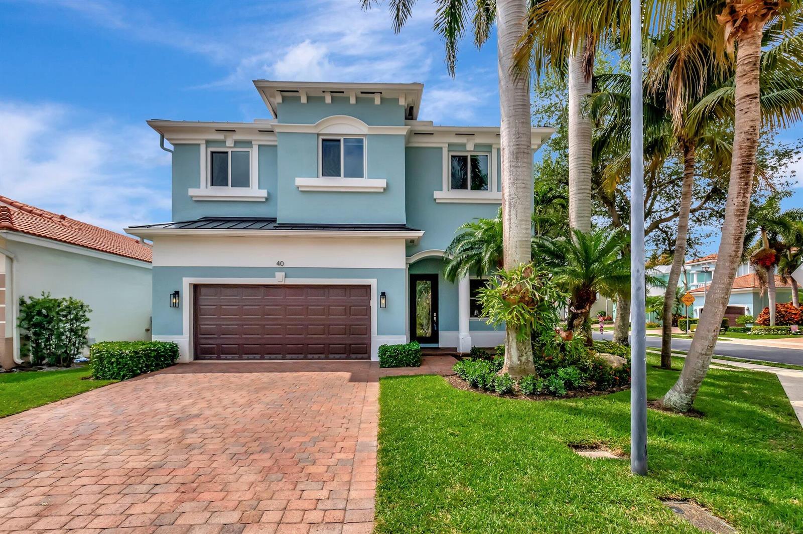 A two-story blue house with a brown garage door and a brick driveway — 40 Country Lake Circle, Boynton Beach FL 33436, BOYNTON BEACH, FL