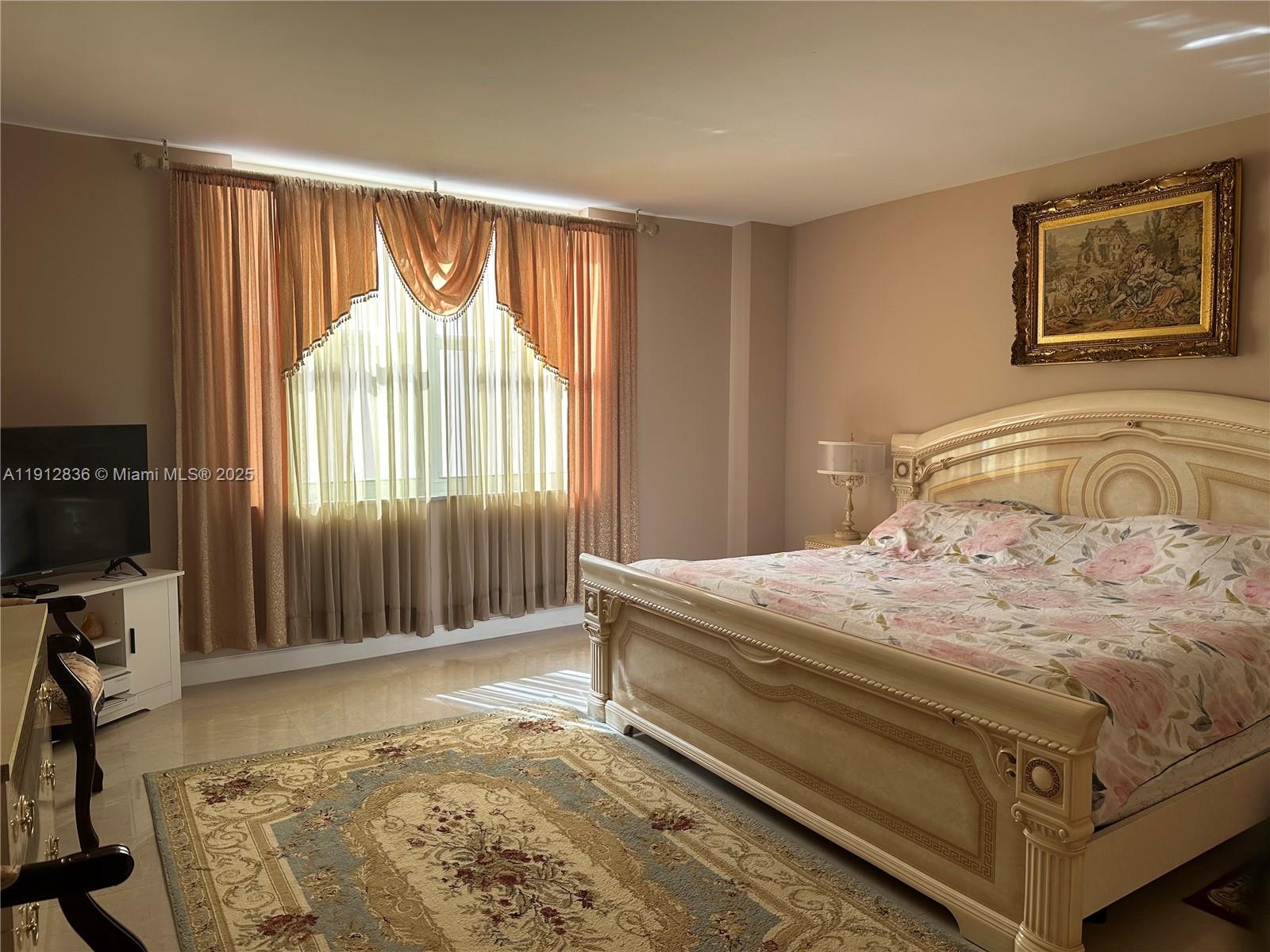 A bedroom features a large ornate bed, a floral rug, and draped window curtains — 1865 S Ocean Dr # 6H, Hallandale Beach FL 33009, HALLANDALE BEACH, FL