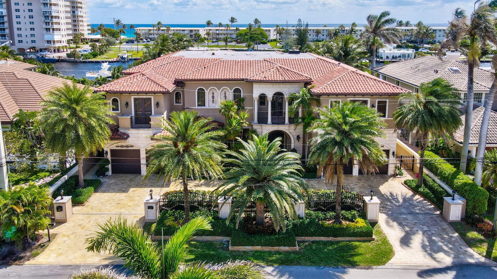 An aerial view of a two-story Mediterranean-style house with a tiled roof and palm trees — 3870 NE 31st Avenue, Lighthouse Point FL 33064, LIGHTHOUSE POINT, FL