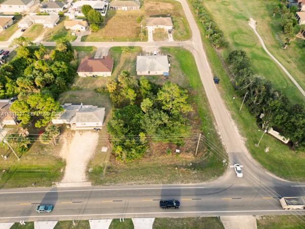 An aerial view shows a vacant lot surrounded by residential houses and a paved road — 4912 LEONARD BLVD S, Lehigh Acres FL 33973, LEHIGH ACRES, FL