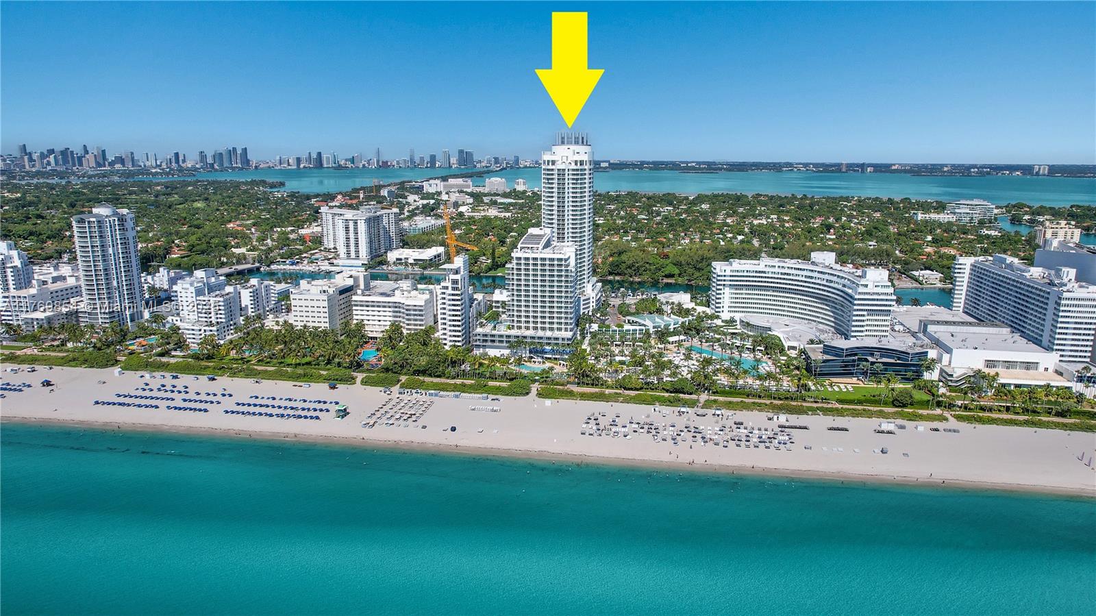 An aerial view shows a tall white residential tower on a beach in Miami — 4401 Collins Ave # 1017, Miami Beach FL 33140, MIAMI BEACH, FL