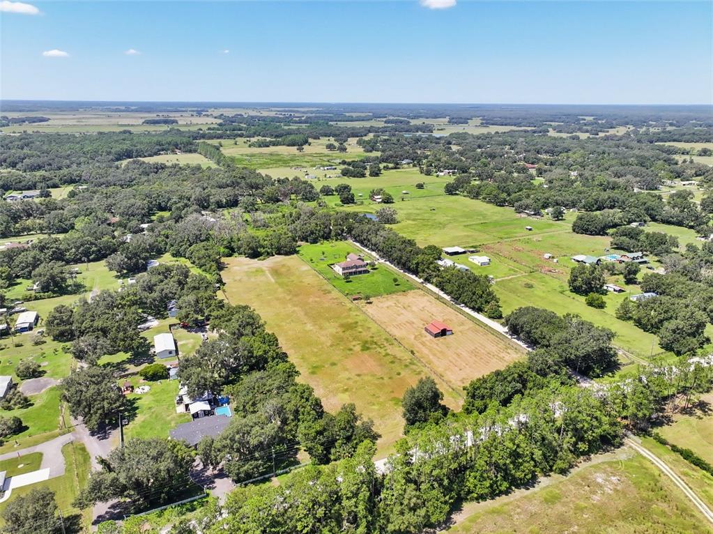 An aerial view shows a large rectangular residential lot with a house and a barn — BELLAMY BROTHERS BOULEVARD, DADE CITY, FL