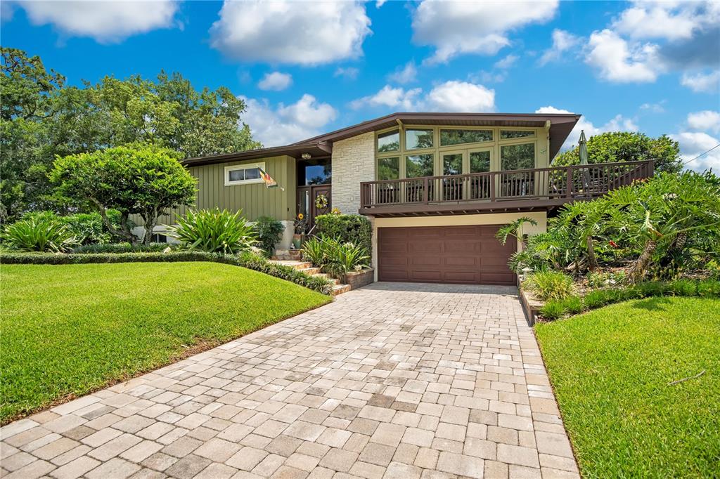 A screened-in swimming pool with a paver deck and outdoor seating area — 800 GATLIN AVENUE, ORLANDO, FL