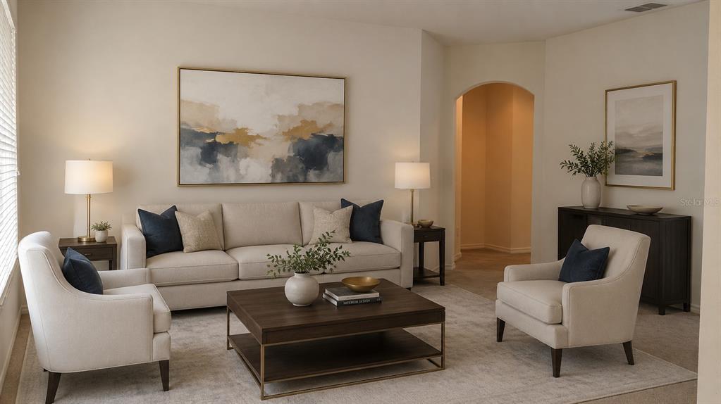 A living room features a beige sofa, two armchairs, a coffee table, and abstract wall art — 609 CEDAR WAXWING DRIVE, BRANDON, FL