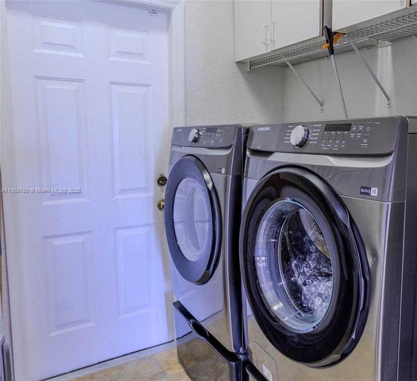 A laundry room features a white door next to two stainless steel Samsung appliances — 14129 SW 31st St, Miramar FL 33027, MIRAMAR, FL
