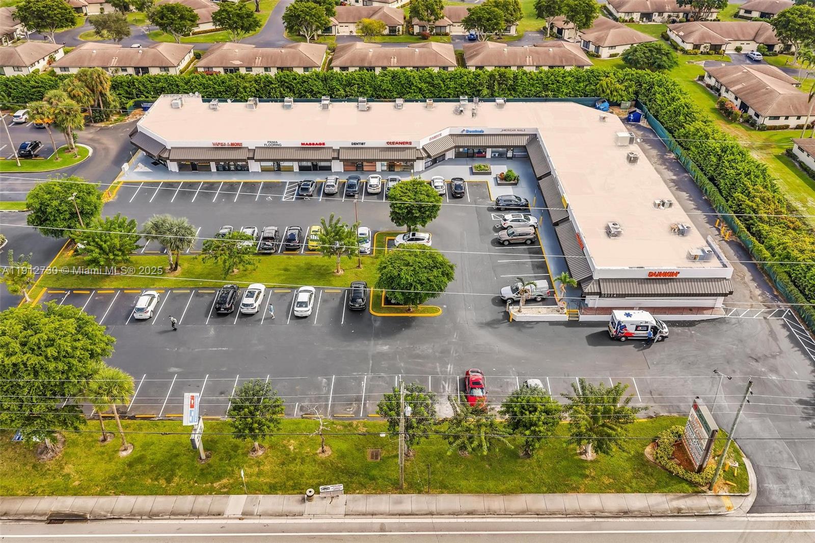 An aerial view shows a commercial strip mall with a parking lot and surrounding landscaping — 10114 S Military Trl, Boynton Beach FL 33436, BOYNTON BEACH, FL