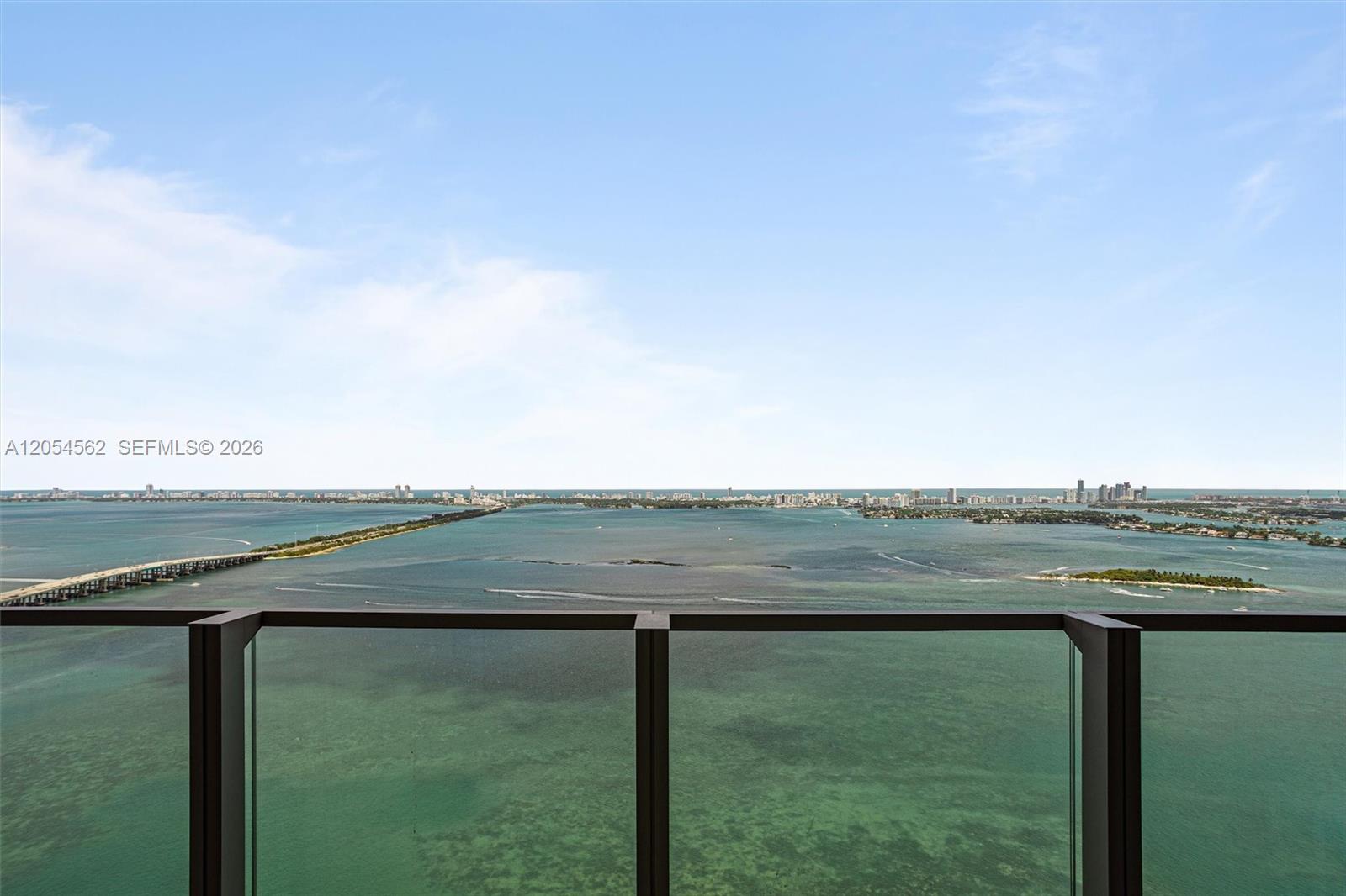 A high-rise balcony overlooks a vast bay with a bridge and distant city skyline — 2900 NE 7th Ave # 4205, Miami FL 33137, MIAMI, FL