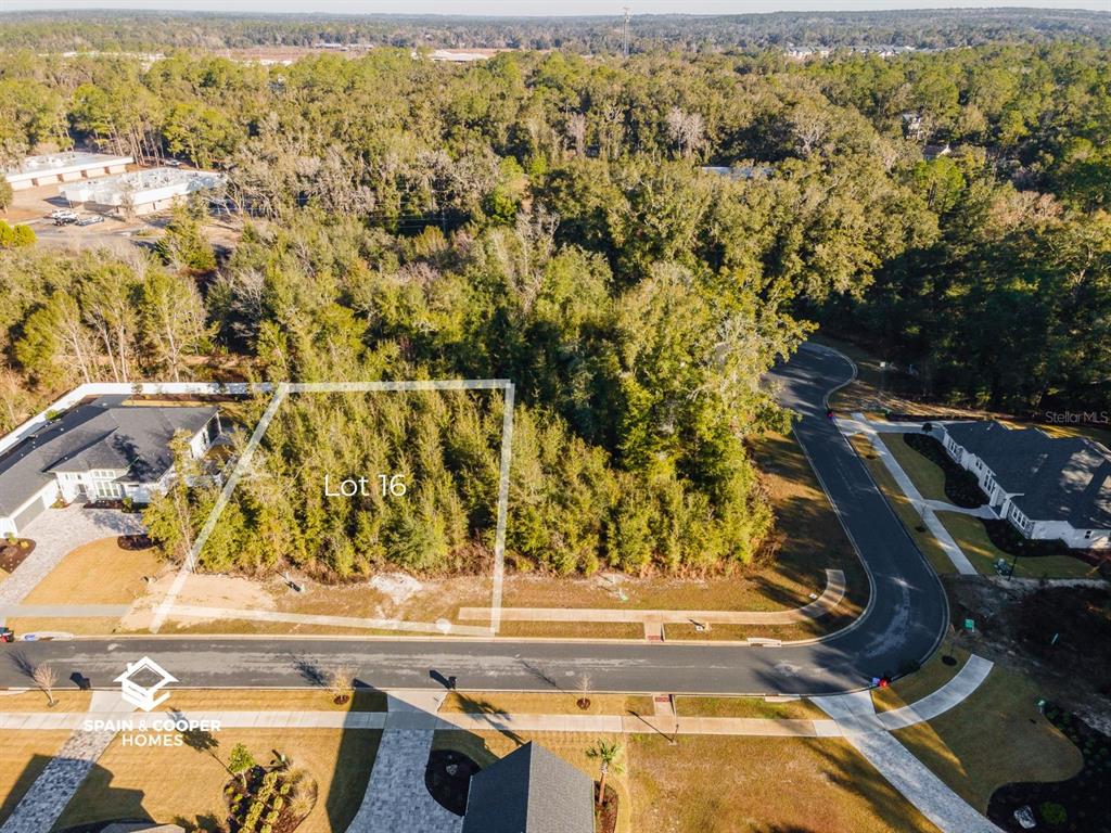 An aerial view shows a vacant, wooded residential lot marked as Lot 16 — 684 SW 139TH COURT, NEWBERRY, FL