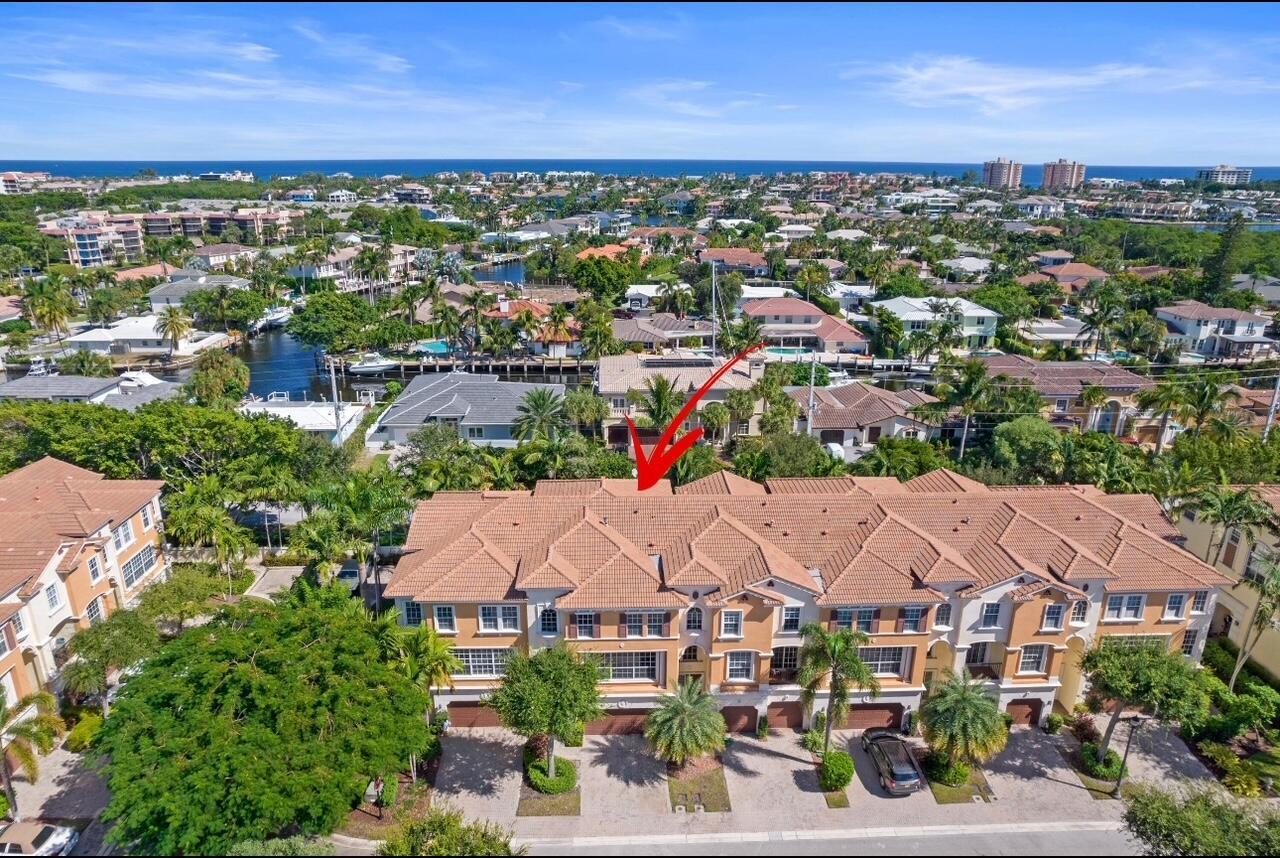 An aerial view of a multi-story residential townhouse complex with a tiled roof — 5660 NE Trieste Way, Boca Raton FL 33487, BOCA RATON, FL