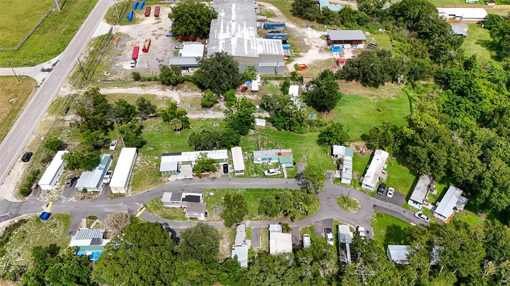 An aerial view shows a mobile home park with several trailers, paved roads, and surrounding trees — 340 RECKER HIGHWAY, AUBURNDALE, FL