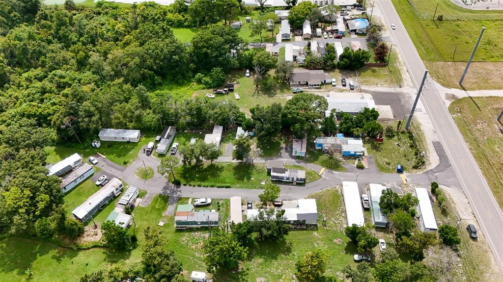Aerial view of a mobile home park with several trailers, trees, and a paved road — 340 RECKER HIGHWAY, AUBURNDALE, FL