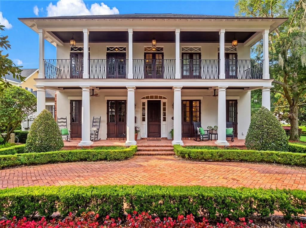 A two-story house with a double-decker porch, white columns, and a brick driveway — 1600 LEGION DRIVE, WINTER PARK, FL