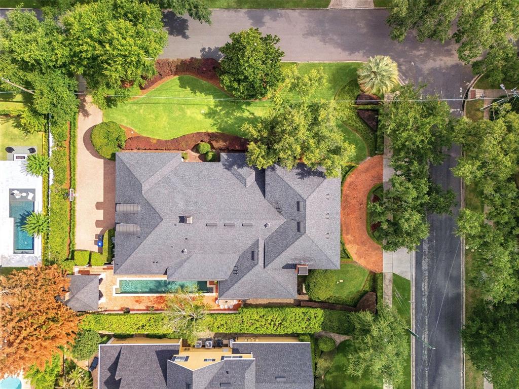 An aerial view shows a house with a gray roof, a pool, and landscaped grounds — 1600 LEGION DRIVE, WINTER PARK, FL