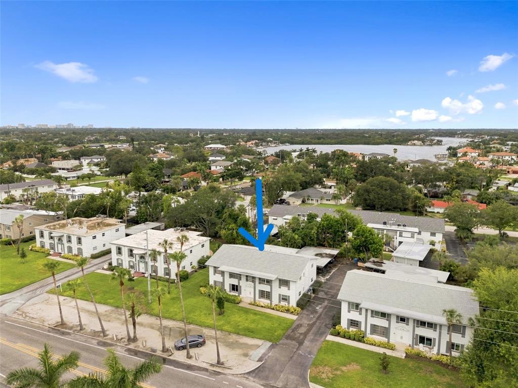 An aerial view shows a two-story apartment building with a gray roof and white siding — 1342 SNELL ISLE BOULEVARD NE UNIT 4, ST PETERSBURG, FL