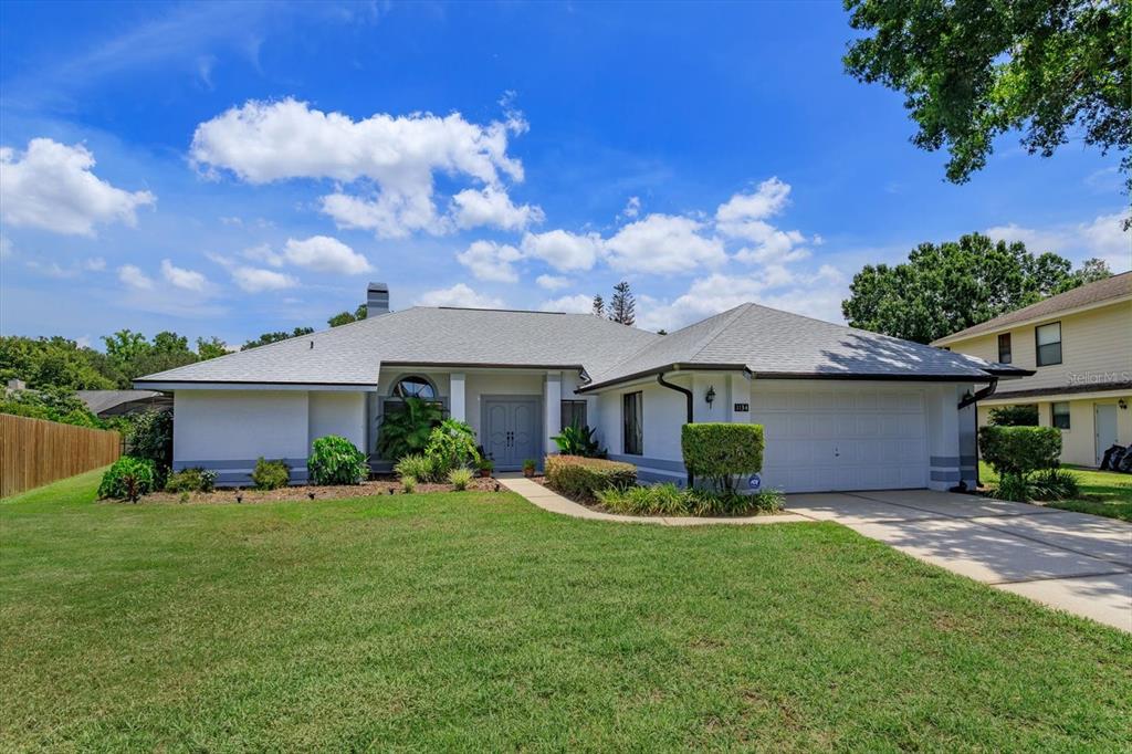 A single-story house with a white exterior, gray roof, and attached two-car garage — 1134 SEAFARER LANE, WINTER SPRINGS, FL