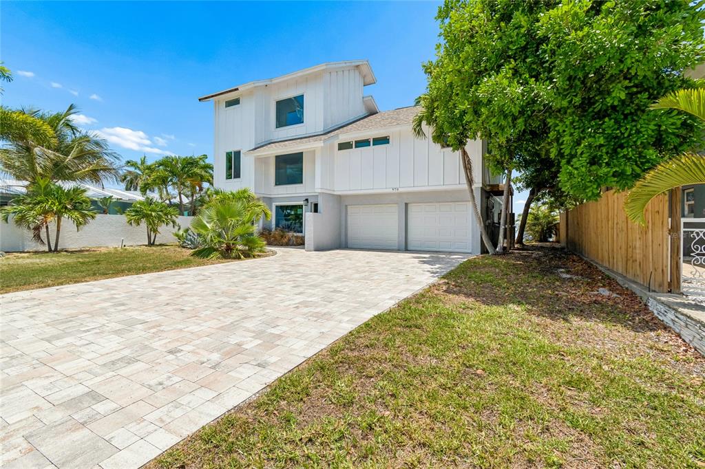 A two-story white house with a paved driveway and a two-car garage — 970 BOCA CIEGA ISLE DRIVE, ST PETE BEACH, FL