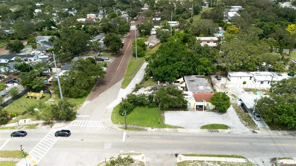 An aerial view shows a street intersection, a small playground, and a residential property — 500 64TH STREET S, ST PETERSBURG, FL