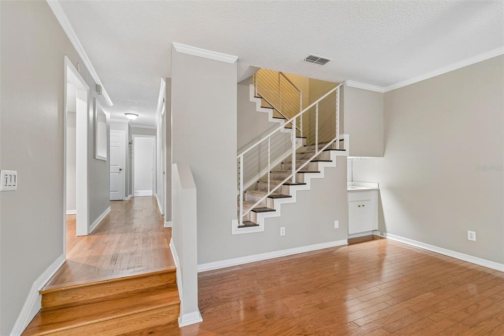 An entryway with hardwood floors, a white front door, a coat closet, and a doorway — 5203 BAYSHORE BOULEVARD UNIT 5, TAMPA, FL