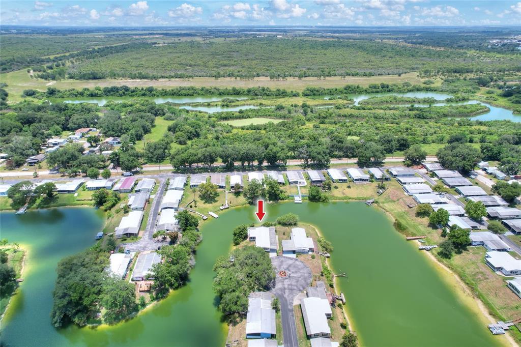 An aerial view of a waterfront mobile home community with a red arrow pointing down — 2055 S FLORAL AVENUE UNIT 246, BARTOW, FL