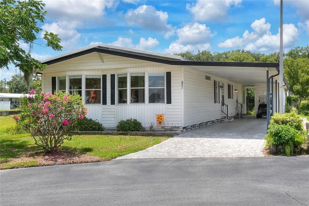 A white single-wide mobile home with a paved driveway and a covered carport — 2055 S FLORAL AVENUE UNIT 246, BARTOW, FL