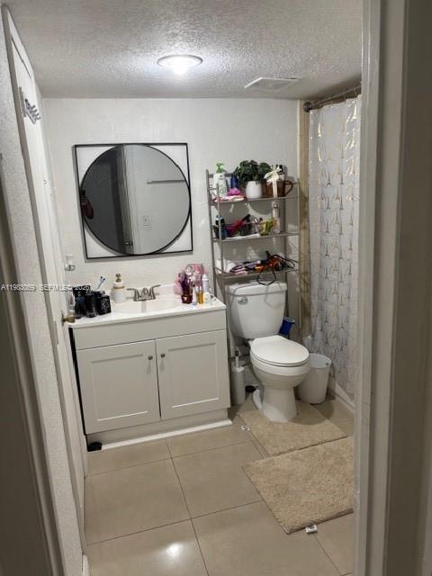 A bathroom features a white vanity, a round mirror, a toilet, and a shower curtain — 1750 W 56 st # 112, Hialeah FL 33012, HIALEAH, FL