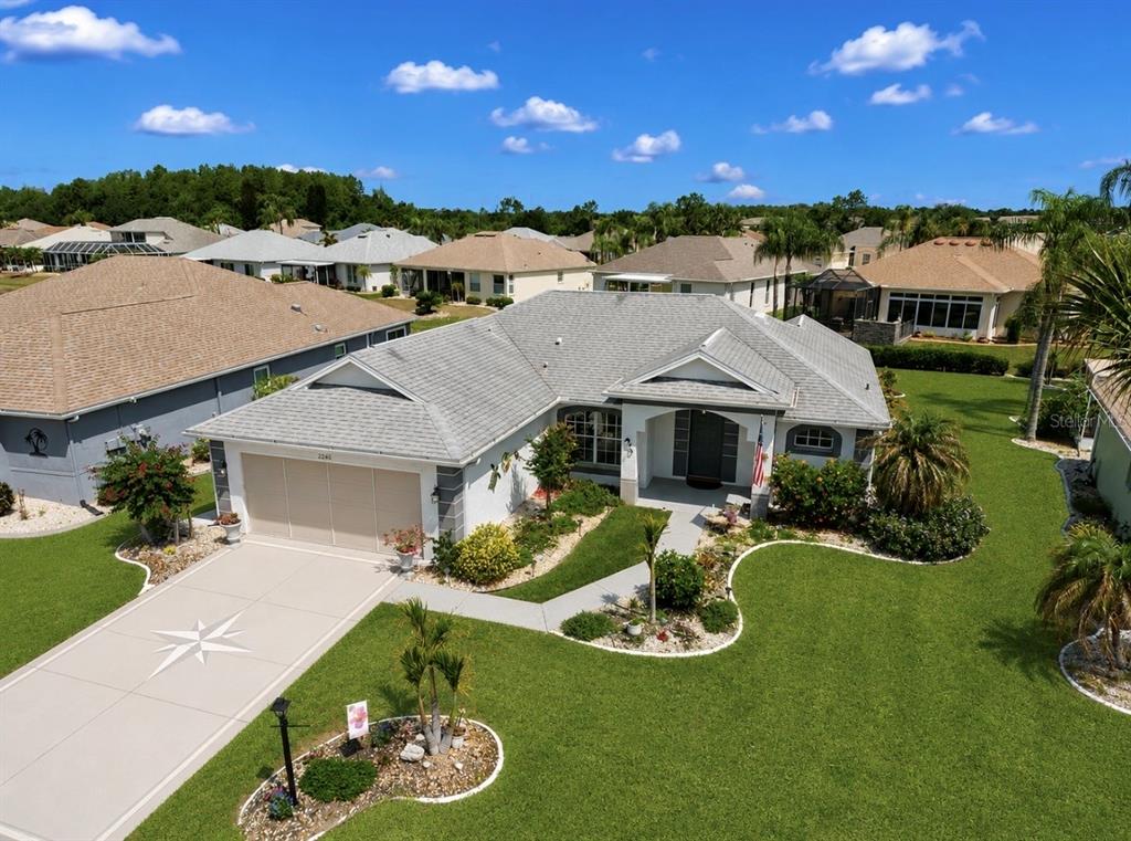 An aerial view of a single-story suburban house with a gray roof and garage — 2240 W DEL WEBB BOULEVARD UNIT 163, SUN CITY CENTER, FL