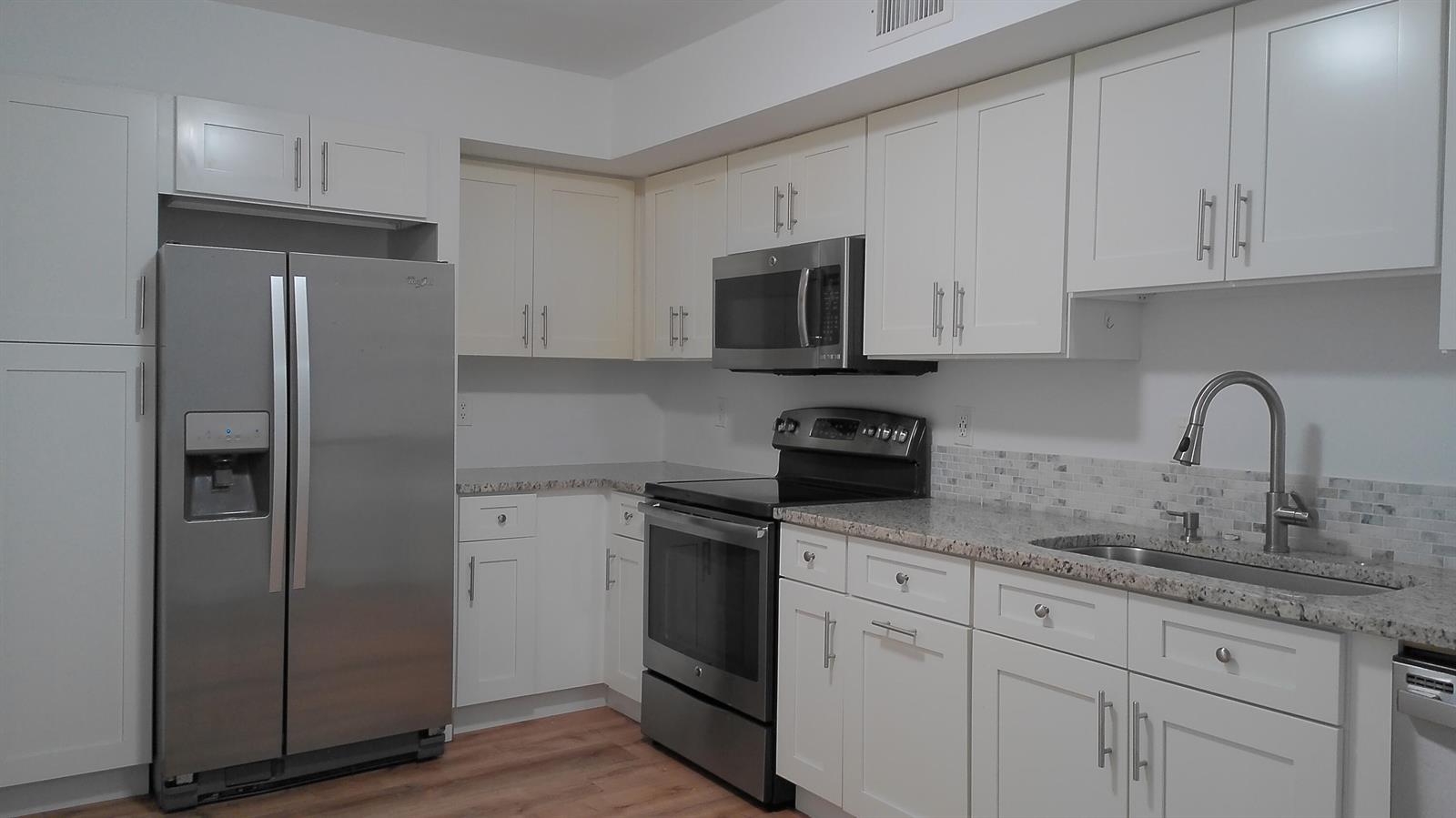 A kitchen with white cabinets, stainless steel appliances, and granite countertops — 3180 Leewood Terrace # L108, Boca Raton FL 33431, BOCA RATON, FL