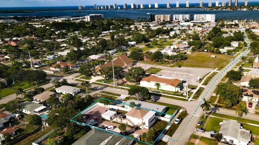 An aerial view shows a residential property outlined in blue near a coastal town — 305 Cypress Drive # 1, Lake Park FL 33403, LAKE PARK, FL