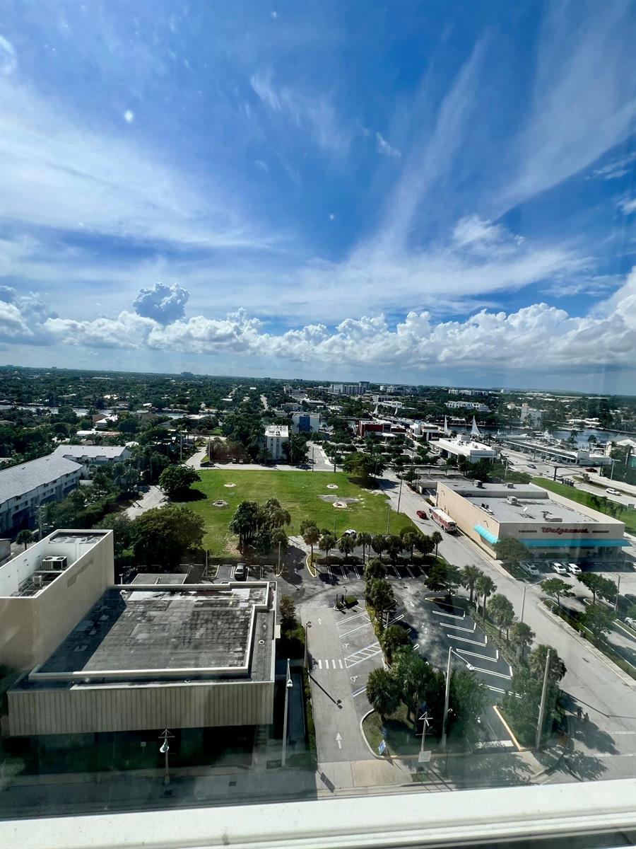 An elevated view shows a city landscape with a large green lot and a Walgreens — 111 Briny Avenue # 1511, Pompano Beach FL 33062, POMPANO BEACH, FL