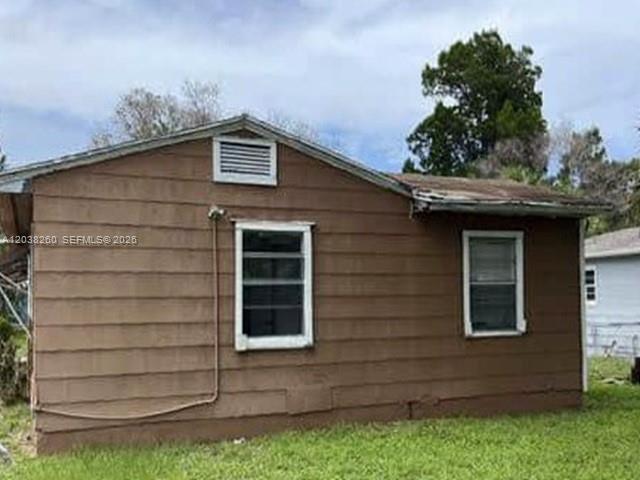 The exterior of a brown, single-story house with two windows and a small roof vent — 314 S 17th St, Fort Pierce FL 34950, FORT PIERCE, FL