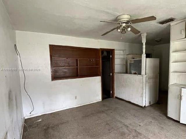 An interior room features a ceiling fan, built-in wooden shelving, and a partial partition wall — 314 S 17th St, Fort Pierce FL 34950, FORT PIERCE, FL