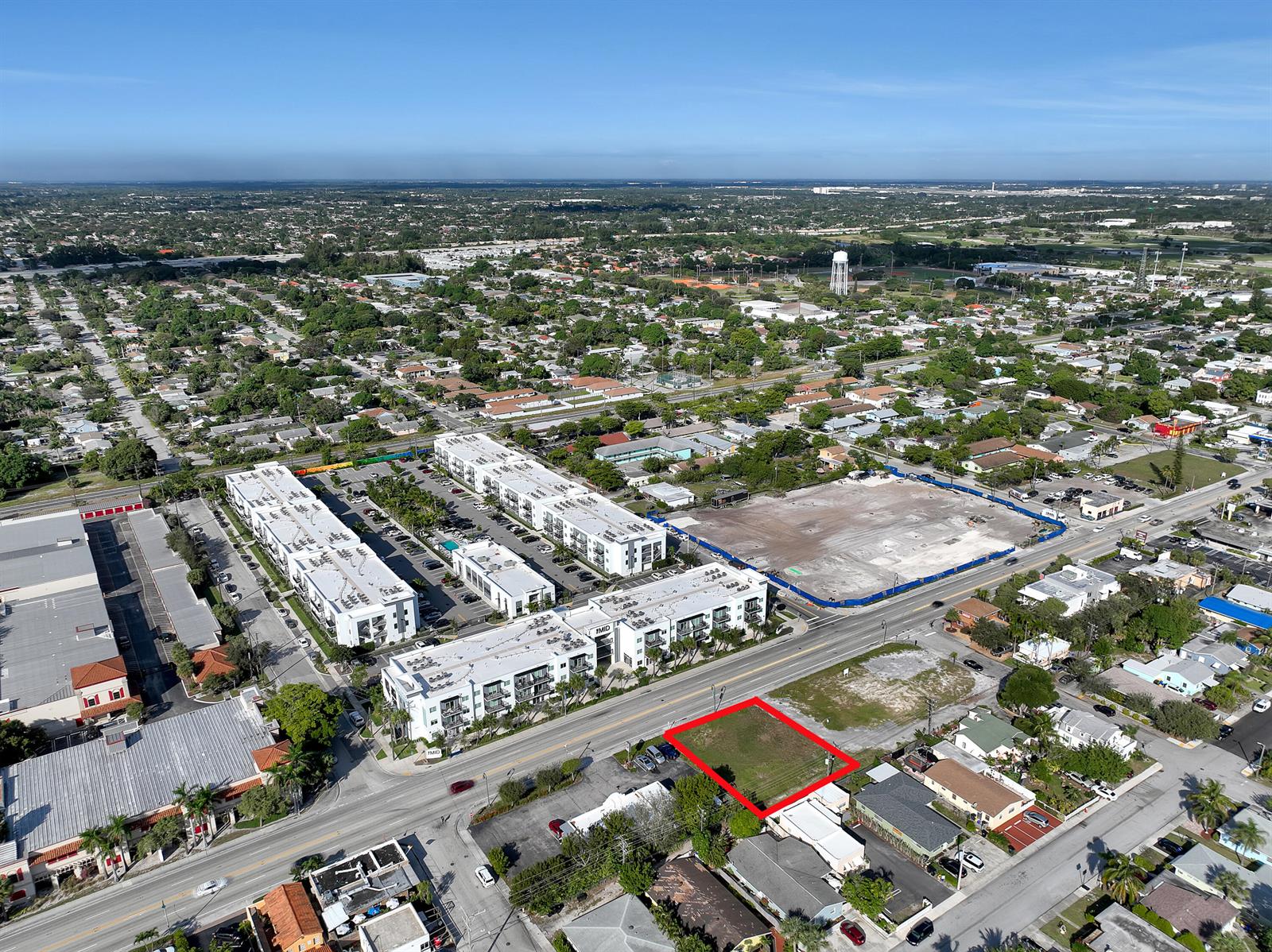 An aerial view shows a vacant rectangular lot outlined in red along a paved road — 1616 N Dixie Highway, FL 33460, FL