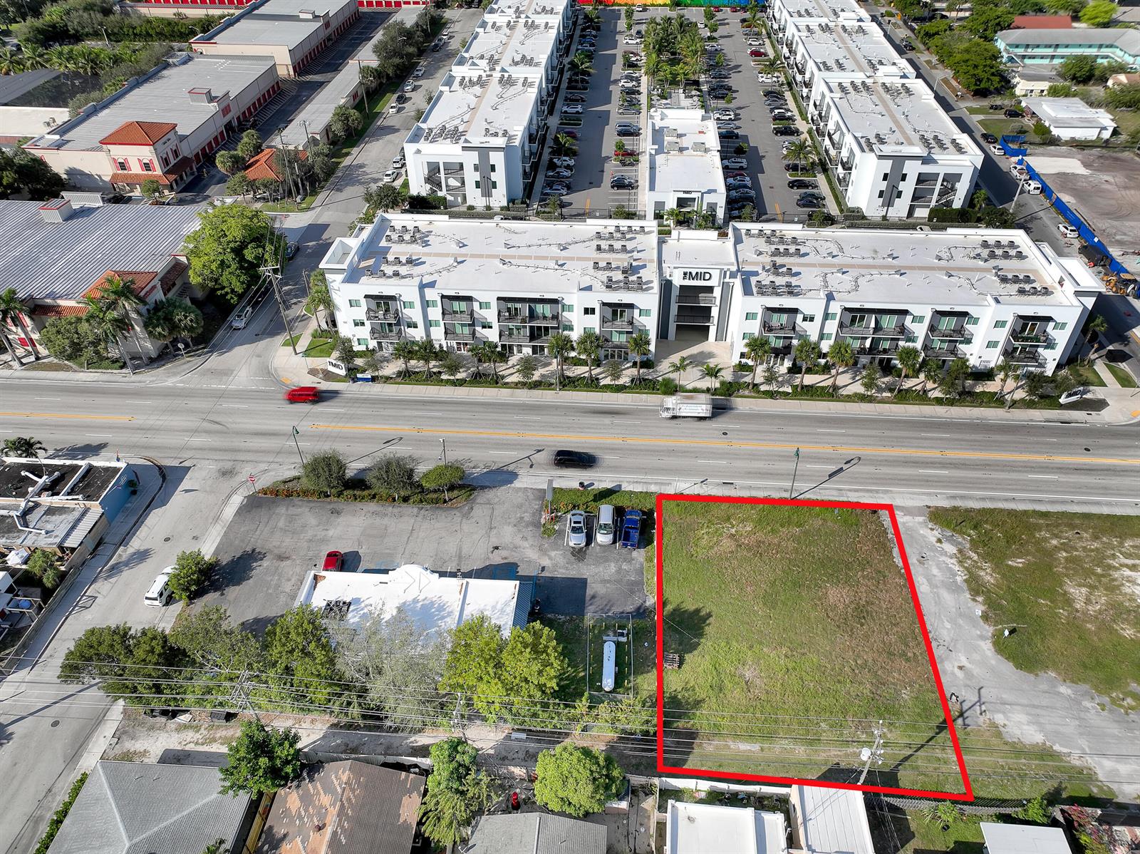 An aerial view shows a vacant rectangular lot outlined in red next to a parking area — 1616 N Dixie Highway, FL 33460, FL