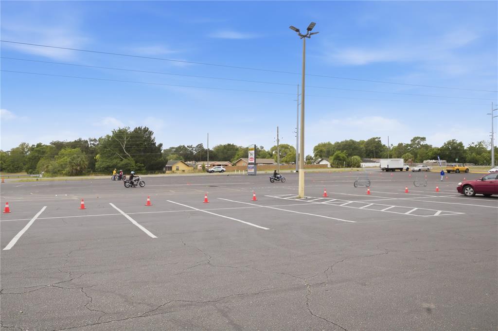 An outdoor parking lot features orange traffic cones and people riding motorcycles — 9413 SE MARICAMP ROAD, OCALA, FL