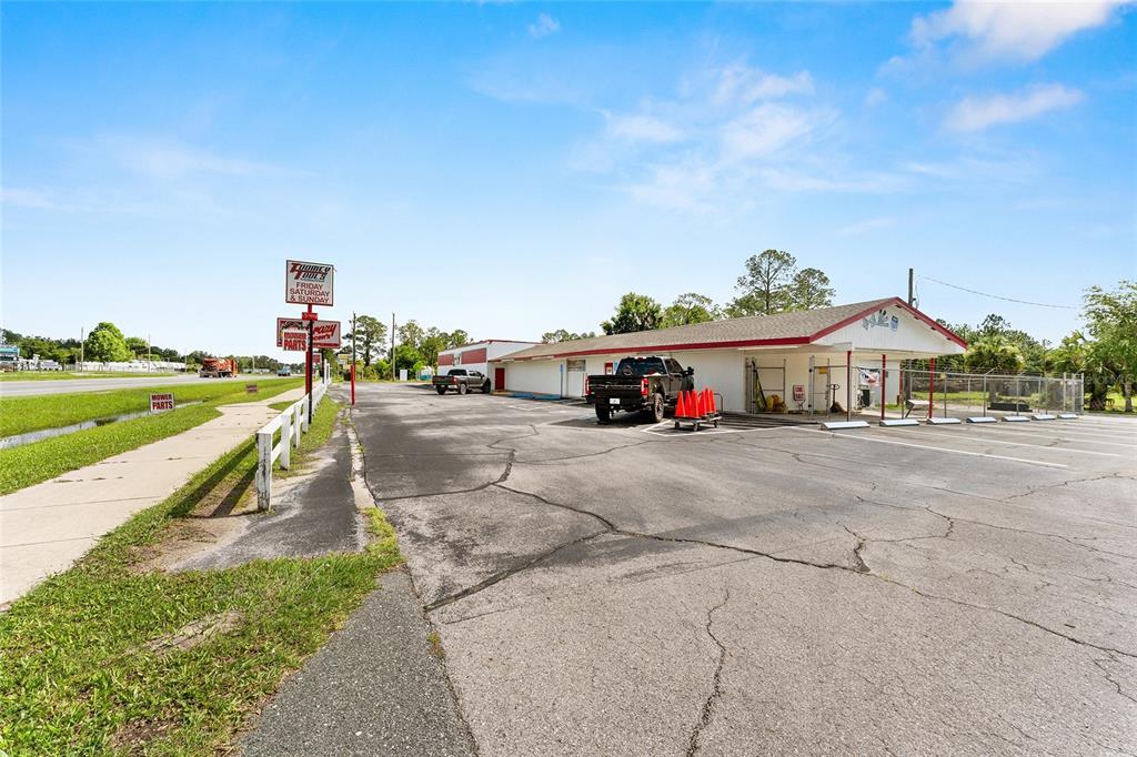 An exterior view of a commercial building with a parking lot and signage — 17313 NE US HWY 301, WALDO, FL