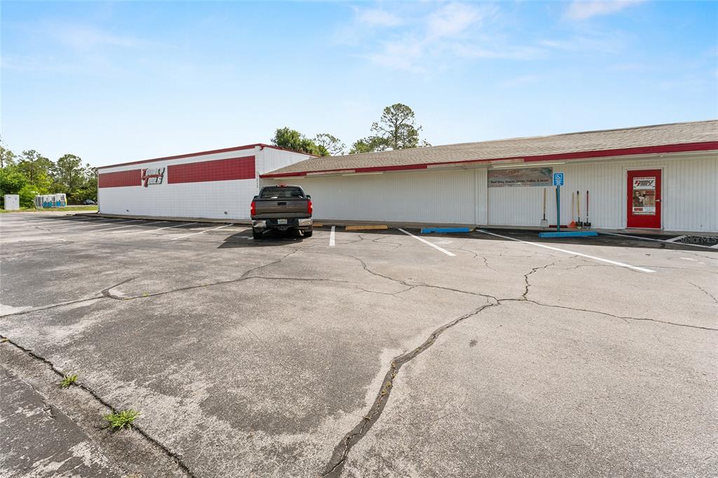 A single-story commercial building with a parking lot and a parked pickup truck — 17313 NE US HWY 301, WALDO, FL