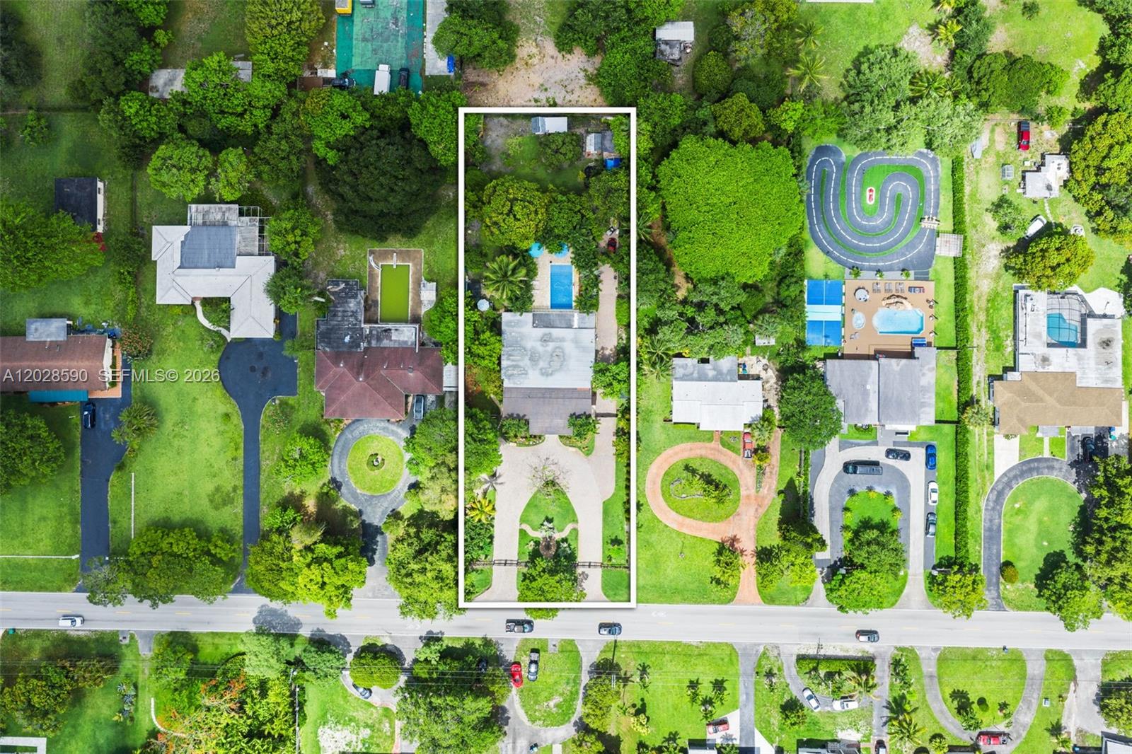 An aerial view shows a residential property with a pool and circular driveway — 13700 N Miami Ave, Miami FL 33168, MIAMI, FL