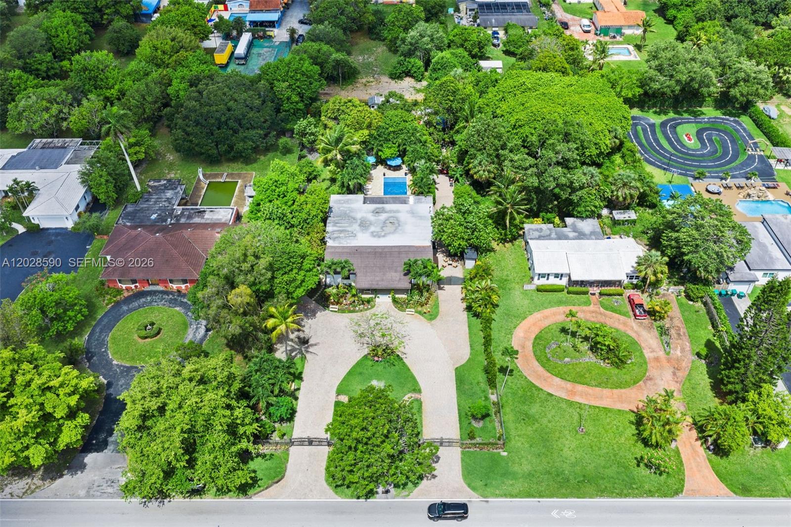 An aerial view shows three houses with driveways, swimming pools, and extensive surrounding trees — 13700 N Miami Ave, Miami FL 33168, MIAMI, FL