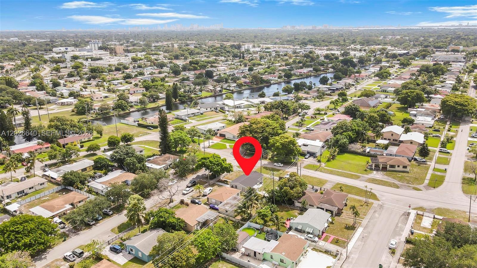 An aerial view shows a residential neighborhood with a red pin marking a single-family house — 1200 NW 87th St # 1, Miami FL 33147, MIAMI, FL