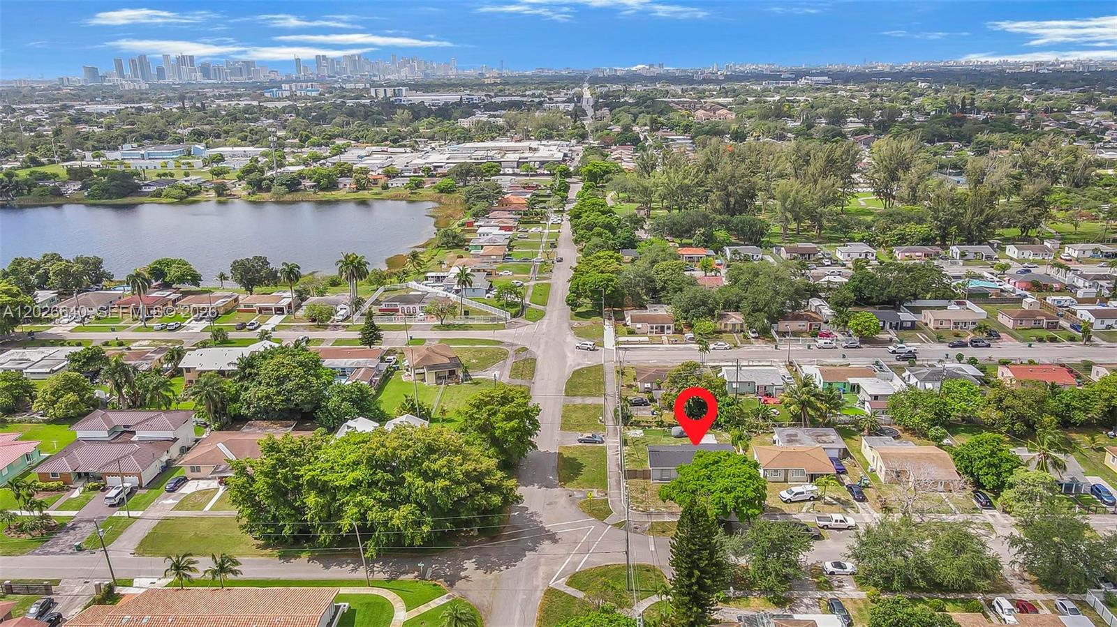 An aerial view shows a residential neighborhood with a red pin marking a single-family house — 1200 NW 87th St # 1, Miami FL 33147, MIAMI, FL
