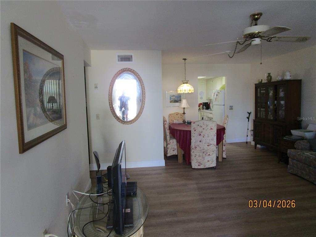 A living and dining area features wood-look flooring, a ceiling fan, and a dining set — 5920 18TH STREET N UNIT 8, ST PETERSBURG, FL