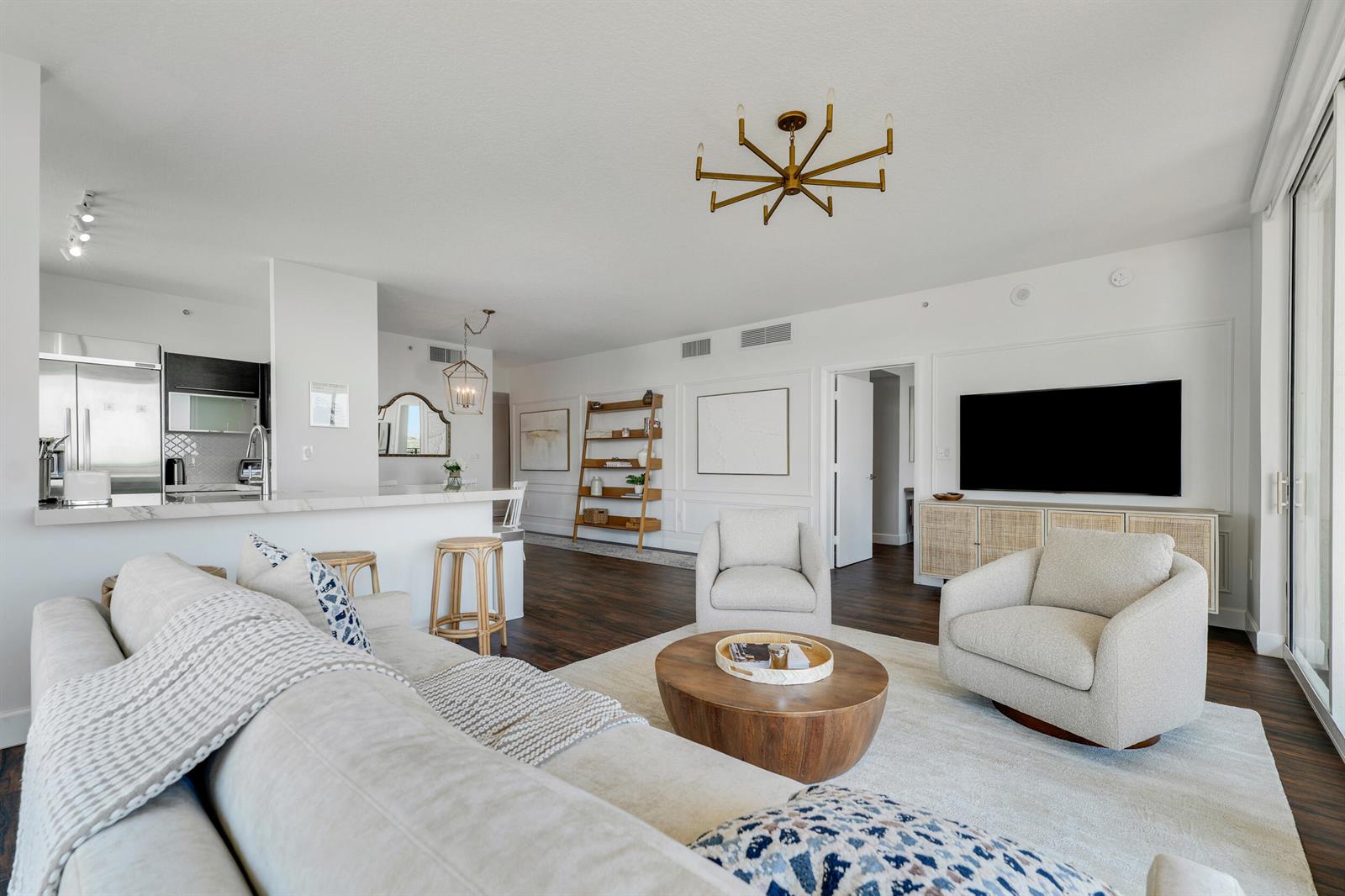 A bright living room features a sectional sofa, two armchairs, a wooden coffee table, and kitchen — 550 Okeechobee Boulevard # 622, West Palm Beach FL 33401, WEST PALM BEACH, FL