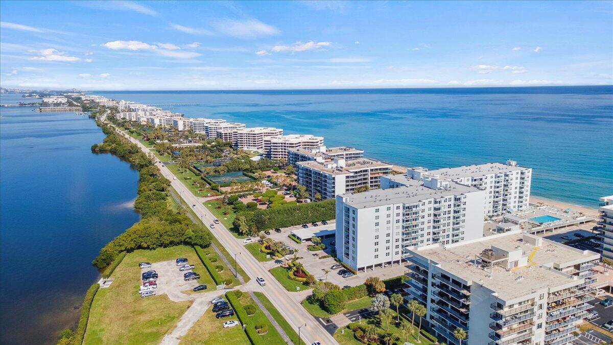 An aerial view of a coastal road lined with apartment buildings between a bay and ocean — 3450 S Ocean Boulevard # 812, Palm Beach FL 33480, PALM BEACH, FL
